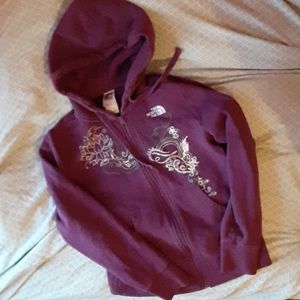 Purple zippered hooded North Face sweatshirt.